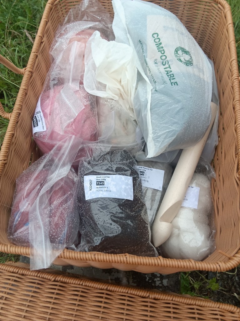 Bottom layer, plastic-wrapped: John Arbon Knit By Numbers 74 'Burgundy' (Merino, 200g) and Devonia 'Furbelows' (50% Exmoor Blueface / 30% Bluefaced Leicester / 20% Romney, 200g); World of Wool's Indulgent collection, Apple Pie, Rhubarb Crumble, Eton Mess, and Tart (Polwarth with nepps, 200g ea); and as palate clensers, 50g each of WoW Irish top in black, and Polwarth tops in white and grey.